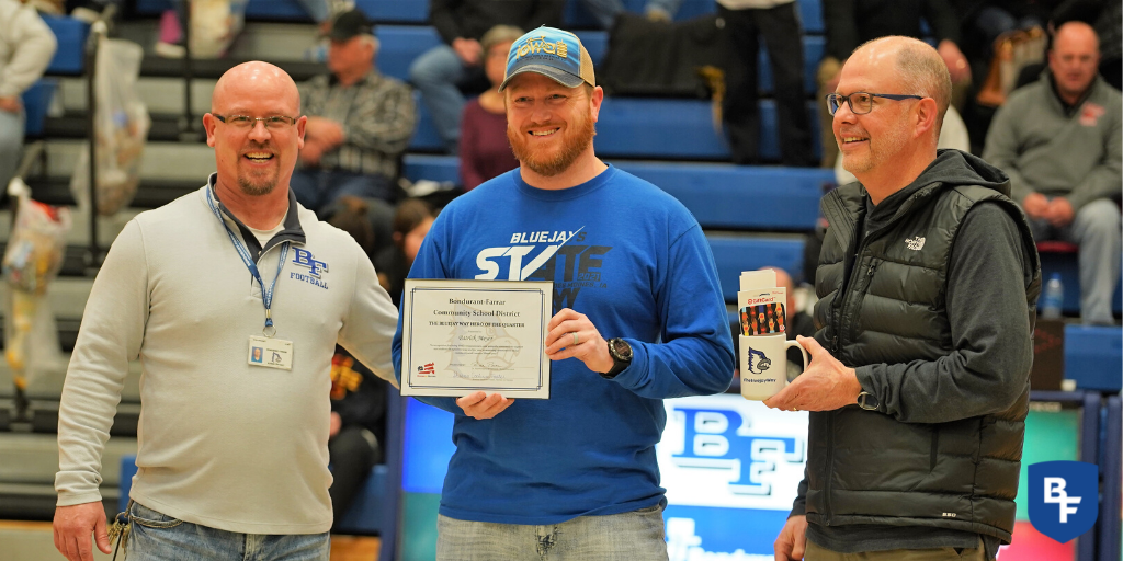 Patrick Meyer, center, was presented with the Bluejay Way Community Partner Award by Ryan Sweeney and Chad Carlson.
